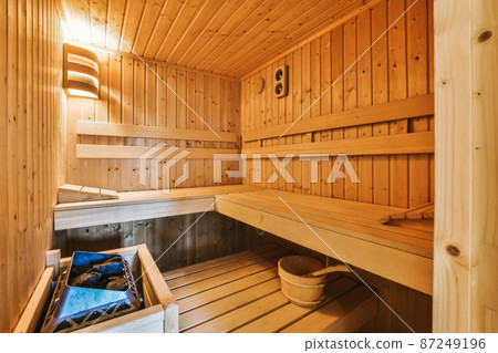 The interior of a comfortable bathhouse with wooden chairs in an elite house The interior of a comfortable bathhouse with wooden chairs in an elite house 87249196