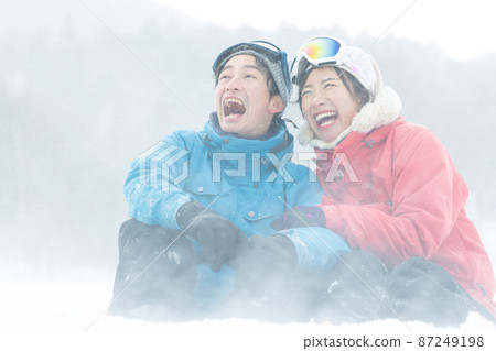 Couple enjoying the snowy mountains Couple enjoying the snowy mountains 87249198