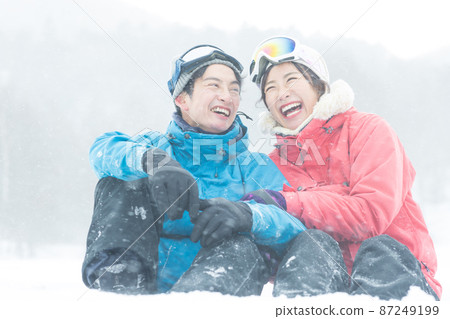 Couple enjoying the snowy mountains Couple enjoying the snowy mountains 87249199