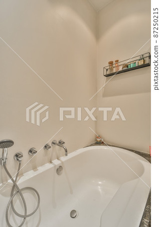 Luxury interior design of a bathroom with marble walls 87250215