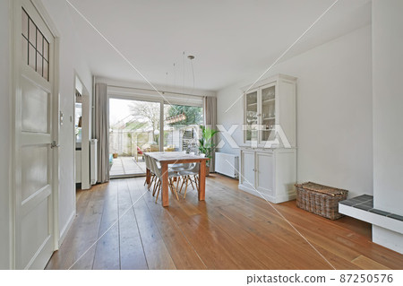 spacious dining area with a wooden table for the whole family spacious dining area with a wooden table for the whole family 87250576
