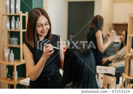 The makeup artist works in her salon, applies professional makeup. Beauty industry, make-up, transformation. The makeup artist works in her salon, applies professional makeup. Beauty industry, make-up, transformation. 87253524