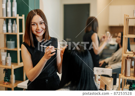 The makeup artist works in her salon, applies professional makeup. Beauty industry, make-up, transformation 87253528