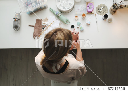 process of making handmade toys. Handicraft, hobby, unique job concept 87254236