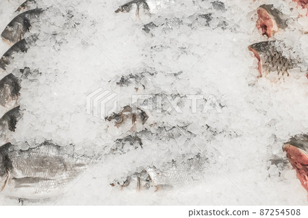 Raw frozen fish cold in ice fresh seafood on the supermarket counter Raw frozen fish cold in ice fresh seafood on the supermarket counter 87254508