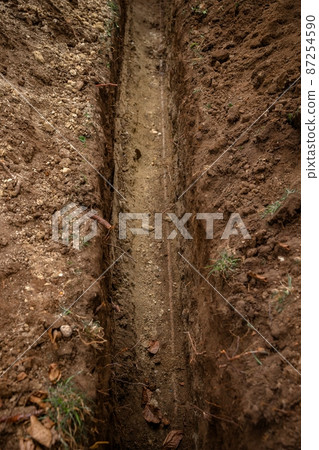 Digging up soil at the pipeline outdoors 87254590
