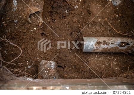 Digging up soil at the pipeline outdoors 87254591