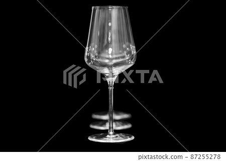 the Netherlands, january 2022. Three wine glasses on black background. 87255278