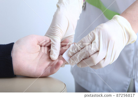 The child gives blood from a finger. in the medical laboratory.Medical laboratory. The concept of healthcare.Close up. The child gives blood from a finger. in the medical laboratory.Medical laboratory. The concept of healthcare.Close up. 87256817