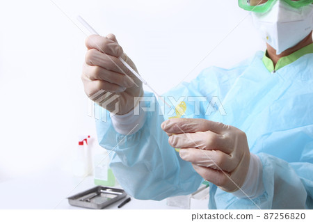 A nurse does a PCR test for covid-19. A PCR test for covid-19. A nurse in protective clothing holds a test tube in her hands. Clinical laboratory. High-precision diagnostics. The face is out of focus. A nurse does a PCR test for covid-19. A PCR test for covid-19. A nurse in protective clothing holds a test tube in her hands. Clinical laboratory. High-precision diagnostics. The face is out of focus. 87256820