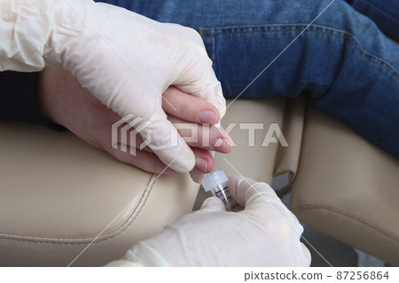 Child gives blood from a finger. Medical laboratory. Close-up. A child's hand. Unrecognizable persons. The concept of healthcare. Prevention of diseases. Child gives blood from a finger. Medical laboratory. Close-up. A child's hand. Unrecognizable persons. The concept of healthcare. Prevention of diseases. 87256864
