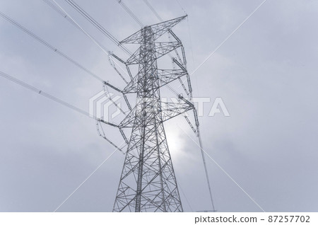 Towers and power lines in the snow 87257702
