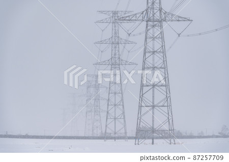 Towers and power lines in the snow 87257709
