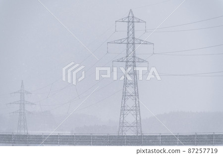 Towers and power lines in the snow 87257719