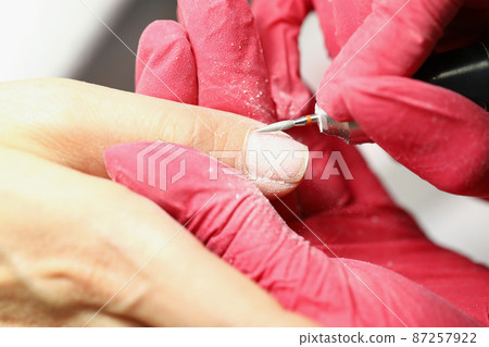 Worker in protective gloves 87257922