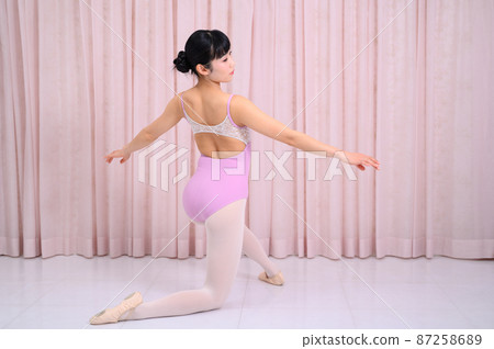 Ballerina kneeling and posing 87258689