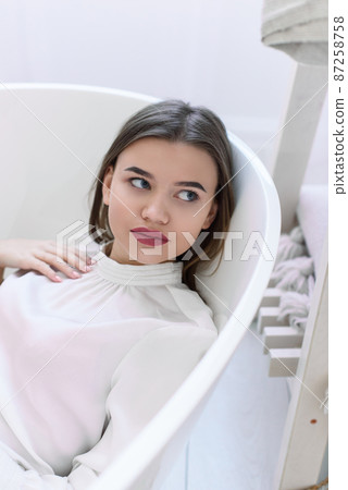 Portrait of fashionable women in a white blouse posing in a bath Portrait of fashionable women in a white blouse posing in a bath 87258758