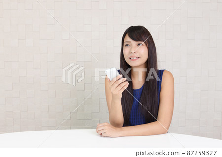 Woman with smartphone Woman with smartphone 87259327
