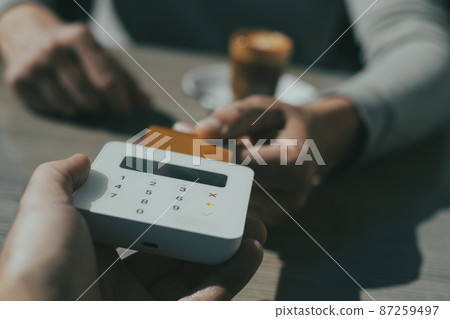man paying the bill using his credit card man paying the bill using his credit card 87259497