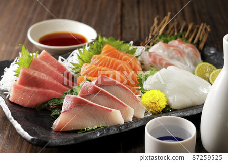 Assortment of sake and sashimi such as bluefin tuna and salmon Assortment of sake and sashimi such as bluefin tuna and salmon 87259525