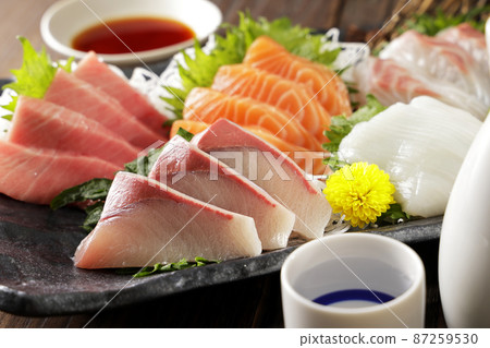 Assortment of sake and sashimi such as bluefin tuna and salmon Assortment of sake and sashimi such as bluefin tuna and salmon 87259530