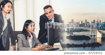 Business people wearing headset working in office broaden view Business people wearing headset working in office broaden view 87259531