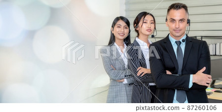 Business people wearing headset working in office broaden view Business people wearing headset working in office broaden view 87260106