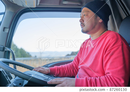 Male driver driving a heavy truck 87260130