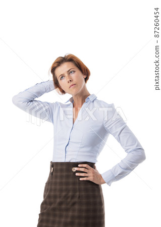 Woman scratching back of head 87260454