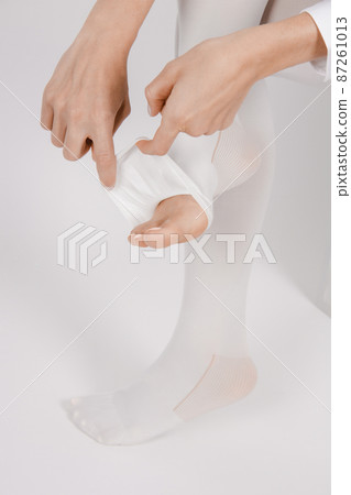 Anti-embolic Compression Hosiery for surgery isolated on white. Medical white stockings, tights for varicose veins and venouse therapy. Thrombo embolic deterrent hose or anti-embolism stockings. Anti-embolic Compression Hosiery for surgery isolated on white. Medical white stockings, tights for varicose veins and venouse therapy. Thrombo embolic deterrent hose or anti-embolism stockings. 87261013