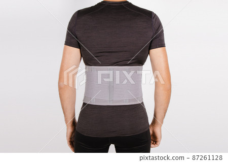 Lumbar brace on the human body isolated on a white background. Trauma of back. Back brace, orthopedic lumbar, support belt for back muscles. Lower back problems health. Lumbar brace on the human body isolated on a white background. Trauma of back. Back brace, orthopedic lumbar, support belt for back muscles. Lower back problems health. 87261128