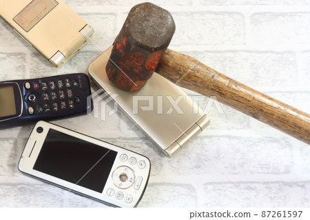 Old cell phone and hammer Old cell phone and hammer 87261597