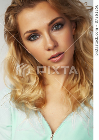 young pretty stylish blond girl posing emotional isolated on white background happy smiling cool smile, lifestyle people concept 87261856