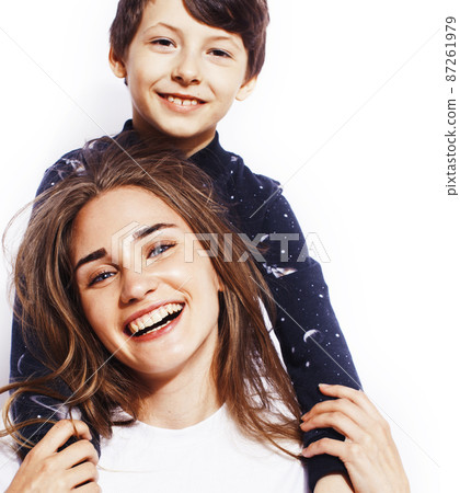 lifestyle and people concept, little cute boy with teenage girl posing together cheerful happy smiling isolated on white background lifestyle and people concept, little cute boy with teenage girl posing together cheerful happy smiling isolated on white background 87261979