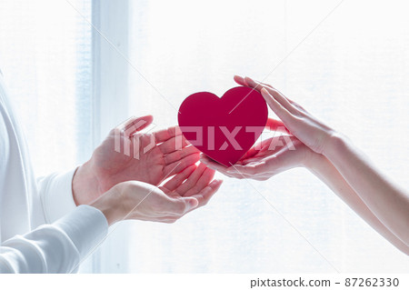 Men and women handing hearts 87262330