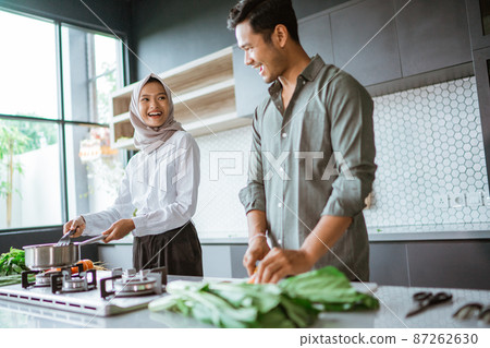 romantic young muslim couple have fun making food at home 87262630
