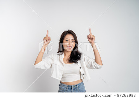attractive asian woman with finger pointing up hand gesture attractive asian woman with finger pointing up hand gesture 87262988