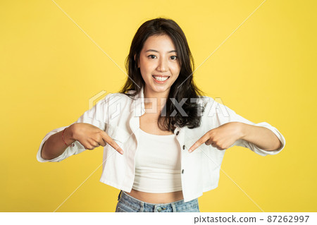 attractive asian woman with finger pointing down attractive asian woman with finger pointing down 87262997