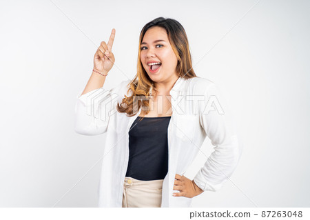 attractive asian woman with finger pointing up hand gesture 87263048
