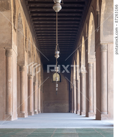 Corridor at the courtyard of the Mosque of Ahmad Ibn Tulun framed by huge decorated arches, Cairo, Egypt 87263166
