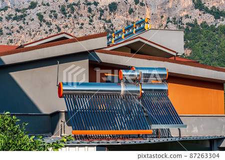solar thermal collectors installed on the roof of a residential building solar thermal collectors installed on the roof of a residential building 87263304