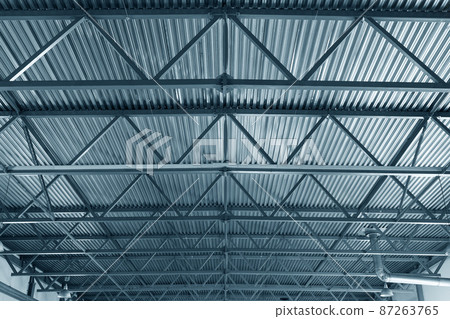 Roof or metal ceiling of industrial premises. Inside view. From bottom up. New building. Metal beams Roof or metal ceiling of industrial premises. Inside view. From bottom up. New building. Metal beams 87263765