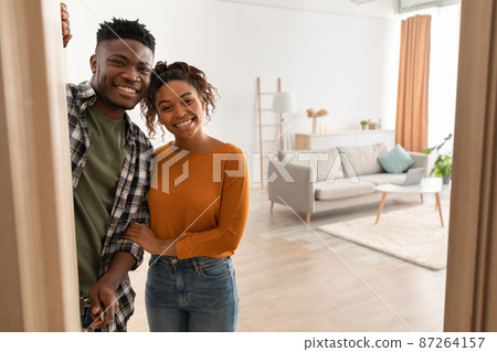 Joyful African Family Couple Embracing Standing In Doors At Home 87264157