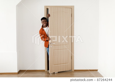 Happy African American Man Smiling Opening The Door At Home 87264244