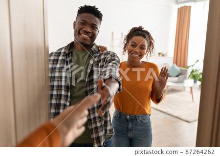 Cheerful Black Spouses Stretching Hands For Handshake Standing Indoors Cheerful Black Spouses Stretching Hands For Handshake Standing Indoors 87264262