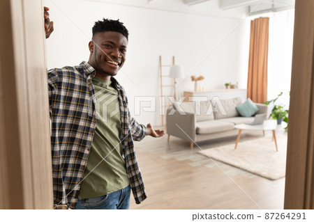 Black Man Opening Door Gesturing Inviting To Come In Indoor 87264291