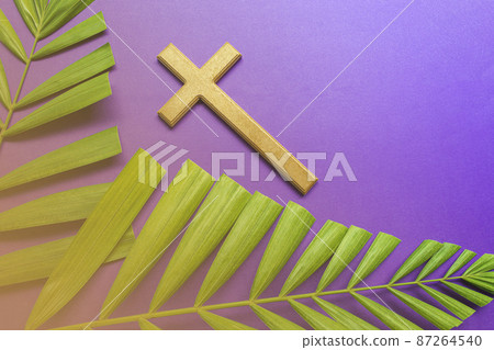 Cross and palm leaves on purple background. Lent season concept. 87264540