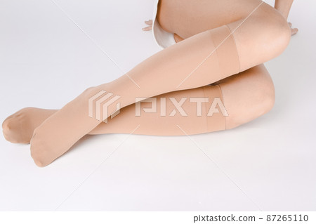 Medical Compression Stockings for varicose veins and venouse therapy. Compression Hosiery. Sock for sports isolated on white background. Black color socks mock up for advertising, branding, design. 87265110