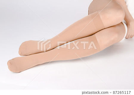 Medical Compression Stockings for varicose veins and venouse therapy. Compression Hosiery. Sock for sports isolated on white background. Black color socks mock up for advertising, branding, design. 87265117