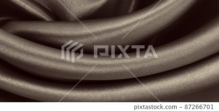 Smooth elegant brown silk or satin texture as abstract background. Luxurious background design. In Sepia toned. Retro style 87266701